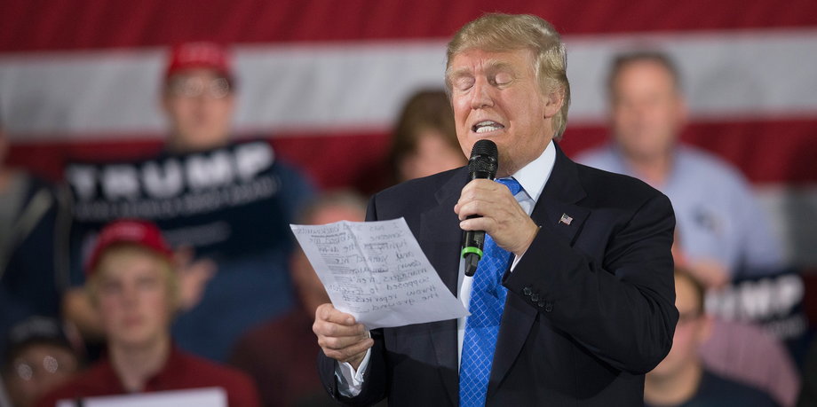 During a campaign rally Republican presidential candidate Donald Trump reads a statement made by Michelle Fields, a former reporter for Breitbart News Service who alleges that Trump's campaign manager Corey Lewandowski assaulted her at a recent press conference, on March 29, 2016 in Janesville, Wisconsin.