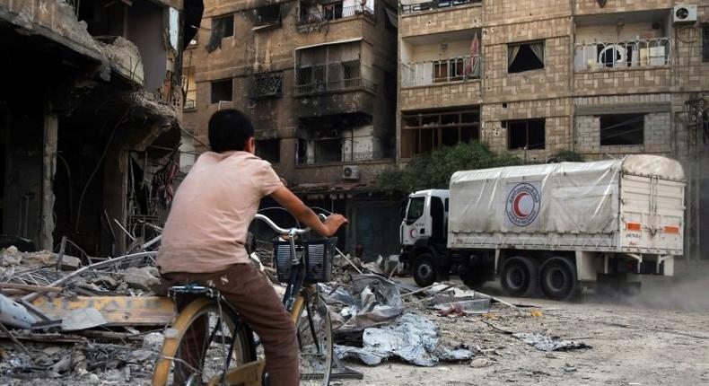 This photo taken on August 29, 2016 shows a Syrian Arab Red Crescent truck in a previous aid delivery to the rebel-held town of Harasta on the outskirts of Damascus