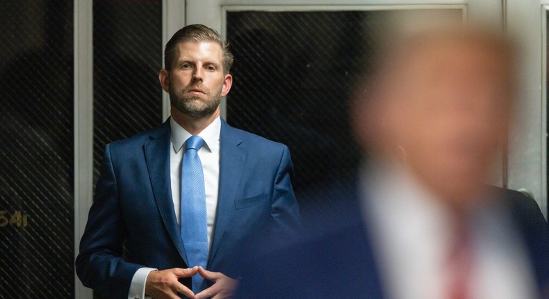 Eric Trump listens as his father, Donald Trump, speaks to the media in the courtroom hallway during the former president's criminal hush-money trial.Justin Lane-Pool/Getty Images