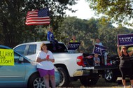 Supporters of U.S. Republican presidential nominee Donald Trump wait outside a campaign rally with U