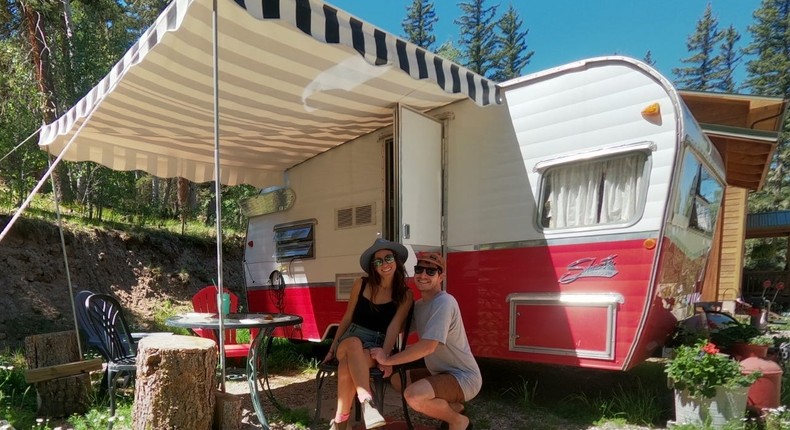 Dylan Barahona and his partner, Mo, in front of their mobile home.
