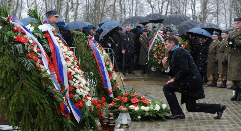 Grieving relatives of the victims of the April 2010 crash of a Polish presidential jet in which president Lech Kaczynski and all 95 other passengers were killed attend a mass during a memorial service at the site of the disaster April 9, 2011