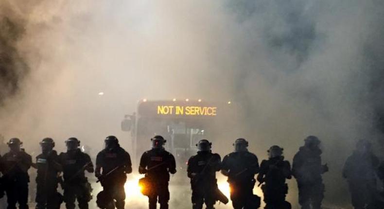 Police officers wearing riot gear block a road during protests after police fatally shot Keith Lamont Scott in the parking lot of an apartment complex in Charlotte, North Carolina, U.S. September 20, 2016. 