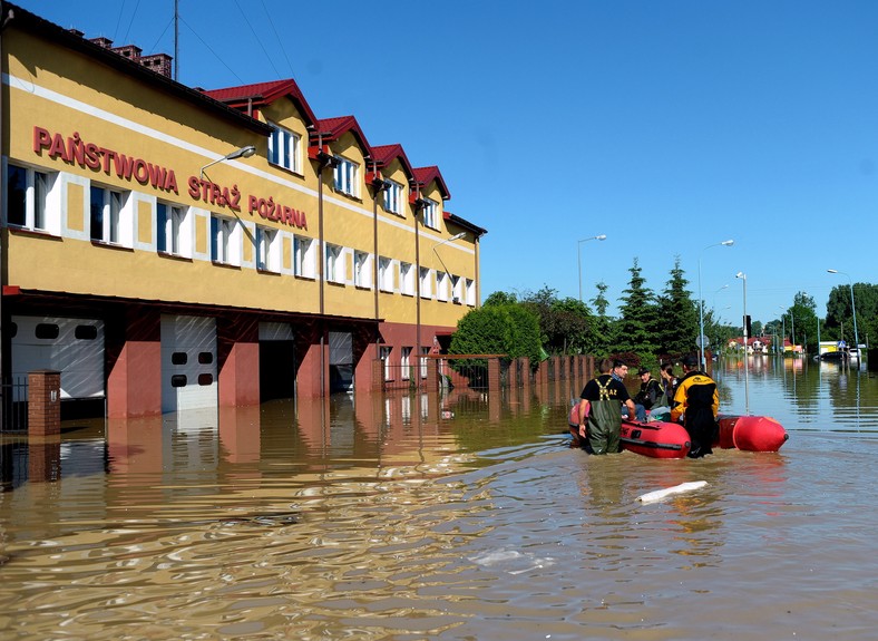 Jasło, 05.06.2010. Strażacy z Komendy Powiatowej Państwowej Straży Pożarnej w Jaśle przed swoją podtopioną jednostką, 5 bm. W Jaśle, zalanym przez rzekę Ropę, trwa ewakuacja. (mr) PAP/Darek Delmanowicz