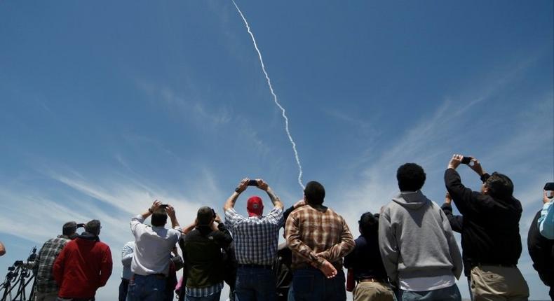 People watch a ground based interceptor missle take off at Vandenberg Air Force base, California on May 30, 2017