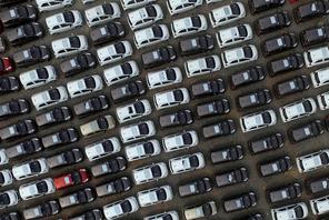 FILE PHOTO: Electric cars are seen at a parking lot of an automobile factory in Xingtai, Hebei provi