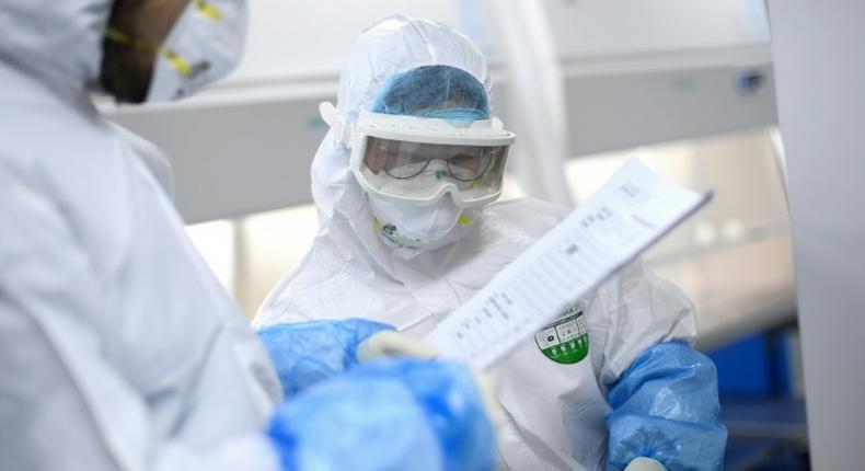 A lab technician works on samples being tested in Wuhan