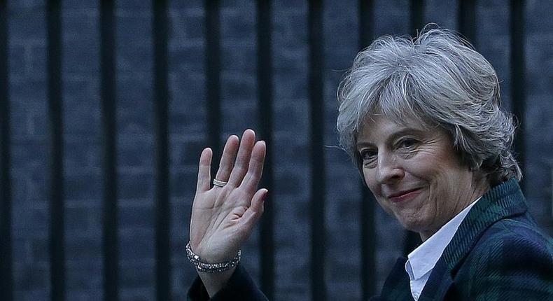 British Prime Minister Theresa May waves as she arrives back at 10 Downing Street in London on January 17, 2017, after delivering a Brexit speech