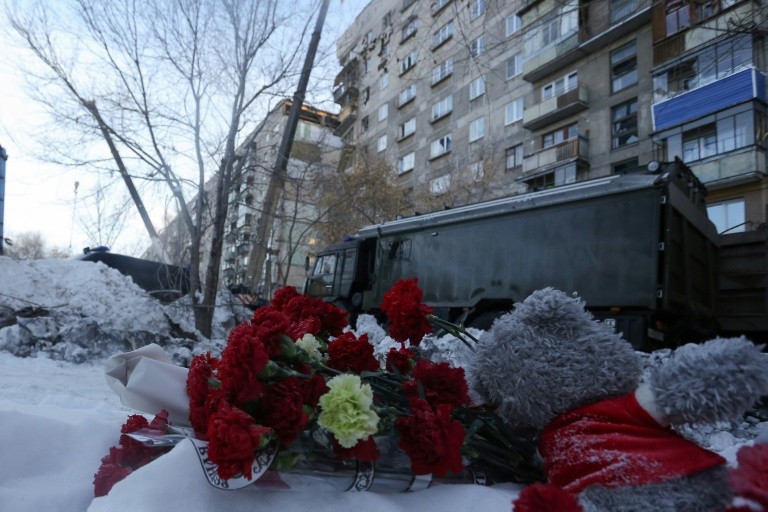 Mourners laid flowers and lit candles near the building