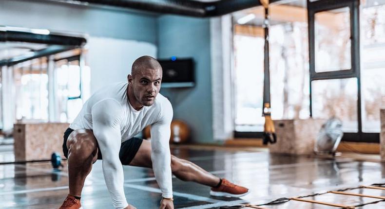 ___8904818___2018___9___26___16___man-stretching-in-the-gym-before-exercise-royalty-free-image-867348060-1537907156