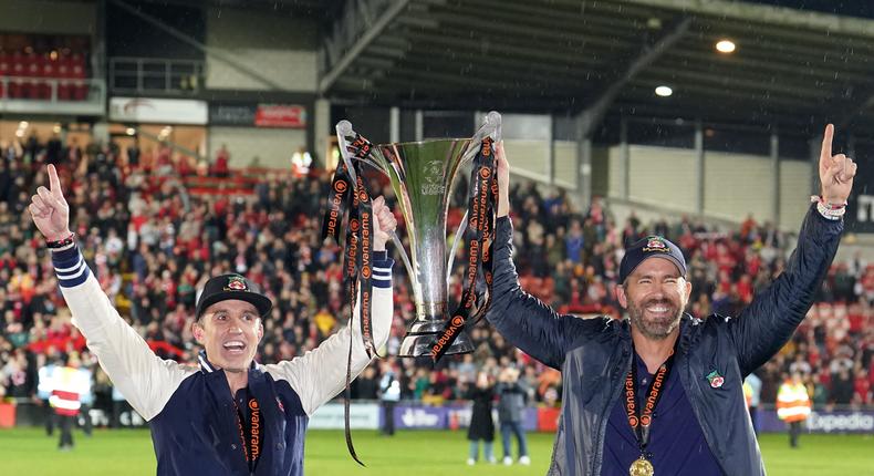 Wrexham co-owners Rob McElhenney and Ryan Reynolds celebrated with the trophy following promotion to the EFL.Martin Rickett/PA Images via Getty Images