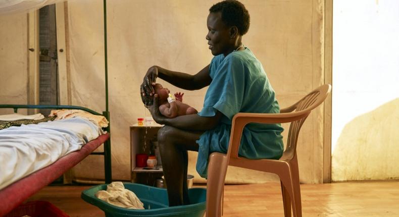 A mother washes her newborn infant at a hospital in a protected civilian site in Malakal, South Sudan. To encourage the peace process the Vatican is hosting a retreat for the warring rival leaders