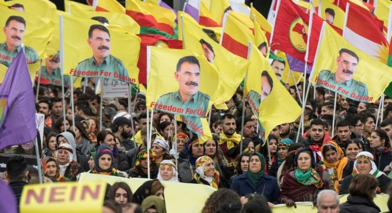 Kurdish protesters demonstrate with placards reading No to dictatorship and the portrait of the leader of the Kurdistan PKK Workers' Party, Abdullah Ocalan in the city center of Frankfurt am Main, western Germany, on March 18, 2017