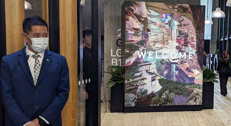 A staff member welcomes guests at a Hong Kong investor showcase for the Saudi Arabia mega-project Neom at the M+ museum for visual culture in Hong Kong on April 19, 2024.HOLMES CHAN via Getty Images