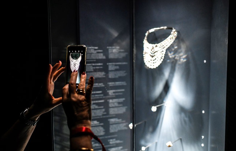 A visitor takes a picture of the platinum and diamond necklace, which dates from 1939 and belonged to Queen Nazli of Egypt, at the Pierres Précieuses exhibition in Paris. Photograph: Stéphane de Sakutin/AFP/Getty