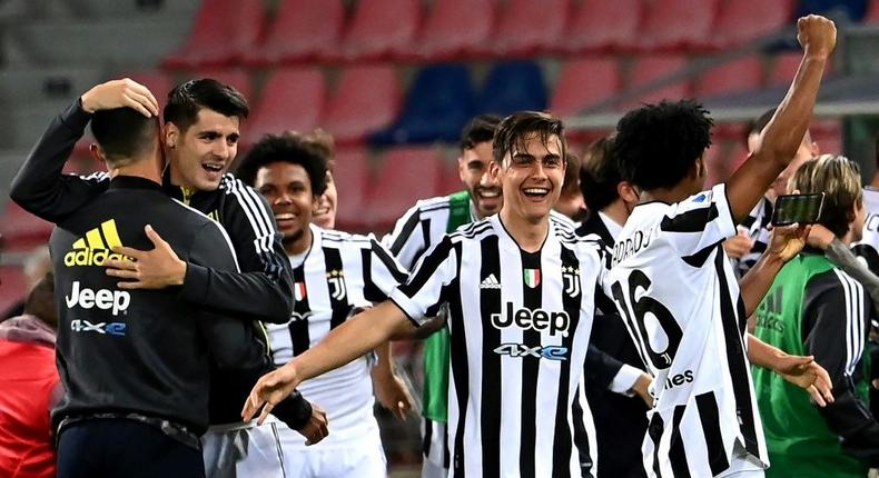 Juventus forward Paulo Dybala (C) and Alvaro Morata (2ndL) celebrate after booking a Champions League berth. Creator: ANDREAS SOLARO
