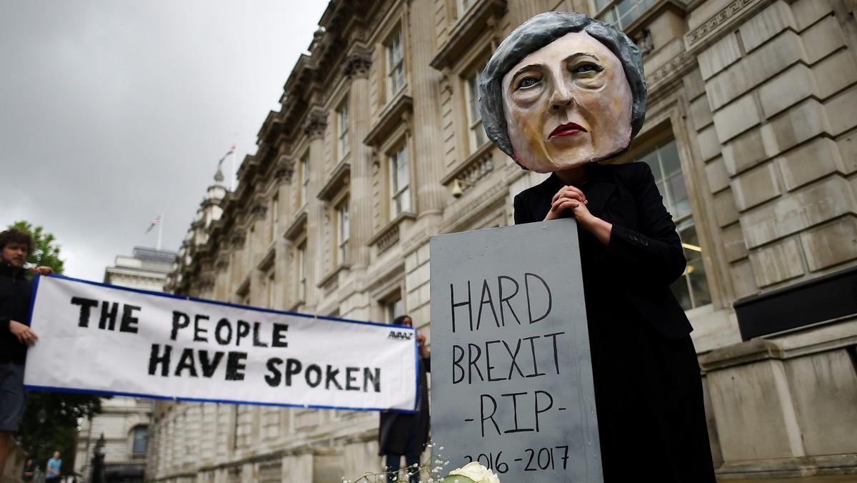 Protestor wearing a Theresa May mask is seen the day after Britain's election in London