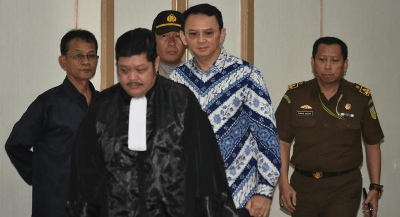 Jakarta's Christian governor Basuki Tjahaja Purnama (2nd R), popularly known as Ahok, arrives at a courtroom for a verdict and sentence in his blasphemy trial