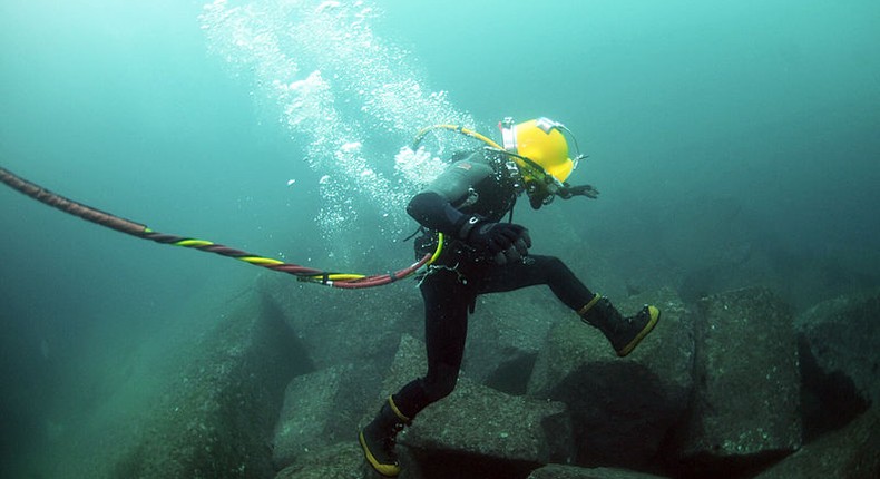A diver repairing an undersea cable