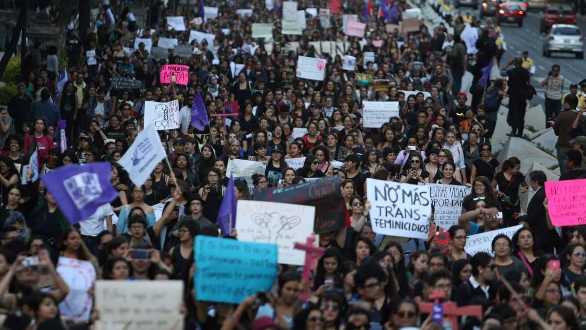 Activists take part in a march to protest violence against women and the murder of a 16-year-old girl in a coastal town of Argentina last week, in Mexico City