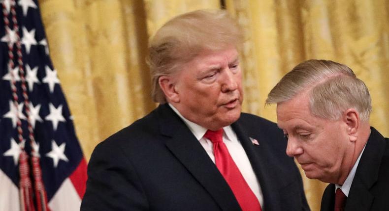 President Donald Trump speaks to Sen. Lindsey Graham (R-SC) during an event about judicial confirmations in the East Room of the White House on November 6, 2019 in Washington, DC.
