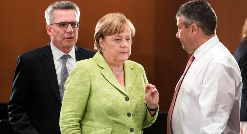 German Chancellor Angela Merkel (C), Interior Minister Thomas de Maiziere (L) and Vice Chancellor and Foreign Minister Sigmar Gabriel attend a meeting with the state Premiers of the German Federal states at the Chancellery on June 1, 2017