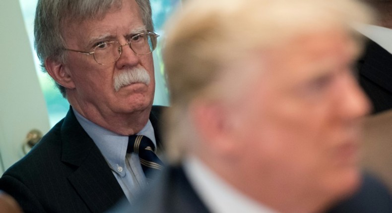 Trump's denial came after The New York Times reported that his former national security advisor John Bolton (L) says in his upcoming book that the president tied Ukraine aid to an investigation of his rivals