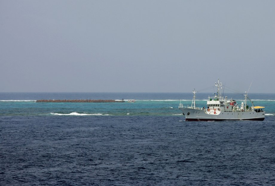 A 50-metre outcropping named Higashikojima (L), protected by a steel net and embankment, is seen from a ship as a Japanese ship sails, off the shore of Okinotori island, about 1,700 km (1,056 miles) south of Tokyo and in the Pacific Ocean, May 20, 2005. Japan says the rocky outcrop is its southernmost island and thus confers fishing and other economic rights in a surrounding exclusive economic zone. Picture taken May 20, 2005.