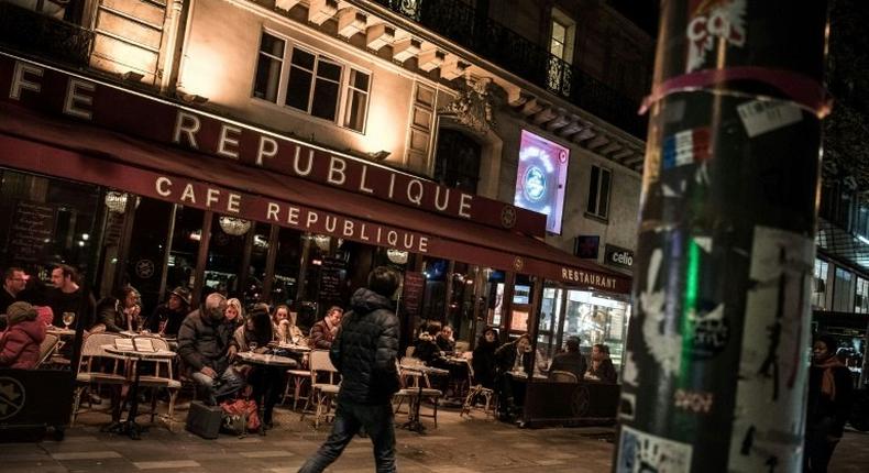 People sit on the terrace of the Cafe Republique near the Place de la Republique in Paris