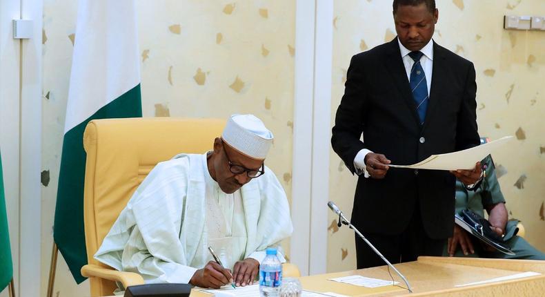 President Muhammadu Buhari signing documents in Abuja on Thursday, August 24, 2017