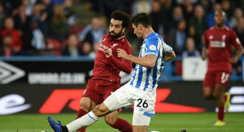 Mohamed Salah shooting beyond the attempted block of Christopher Schindler as he scores the only goal in Liverpool's 1-0 win away to Huddersfield