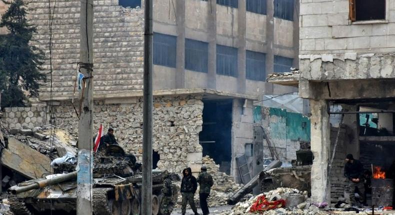 Syrian pro-government forces advance in the Jisr al-Haj neighbourhood during the ongoing military operation to retake remaining rebel-held areas in the northern embattled city of Aleppo on December 14, 2016