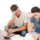 Worried couple doing their accounts in the living room