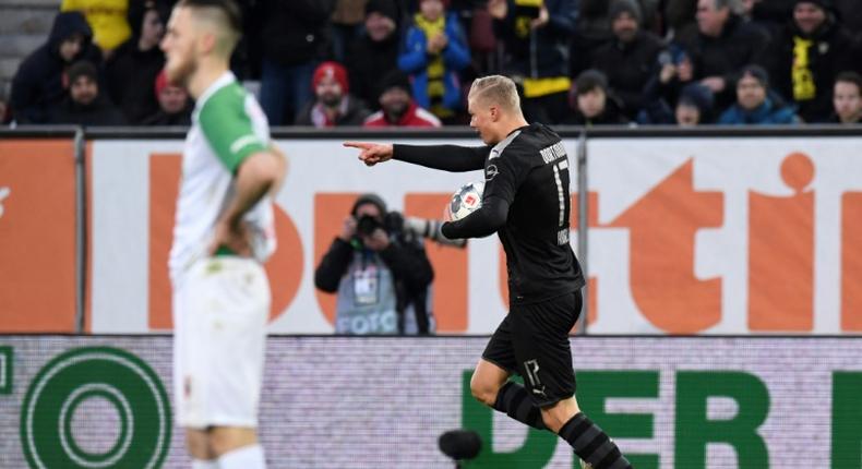 Dortmund's Norwegian forward Erling Haaland (R) celebrates his hat-trick inside 20 minutes in Saturday's stunning 5-3 league win at Augsburg.