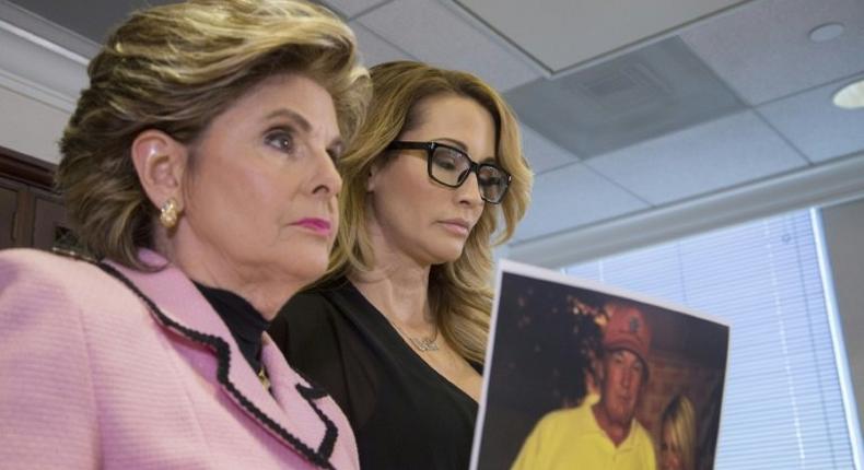 Attorney Gloria Allred holds a photo of Jessica Drake (R) with Donald Trump, taken in 2006 during an event where Drake alleges Trump behaved in an sexually inappropriate way toward her