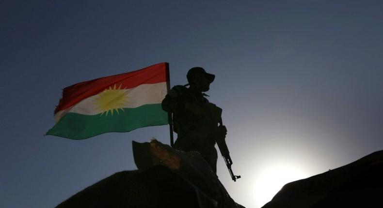 An Iraqi Kurdish Peshmerga fighter holds a position in Sheikh Ali village near the town of Bashiqa, on November 6, 2016