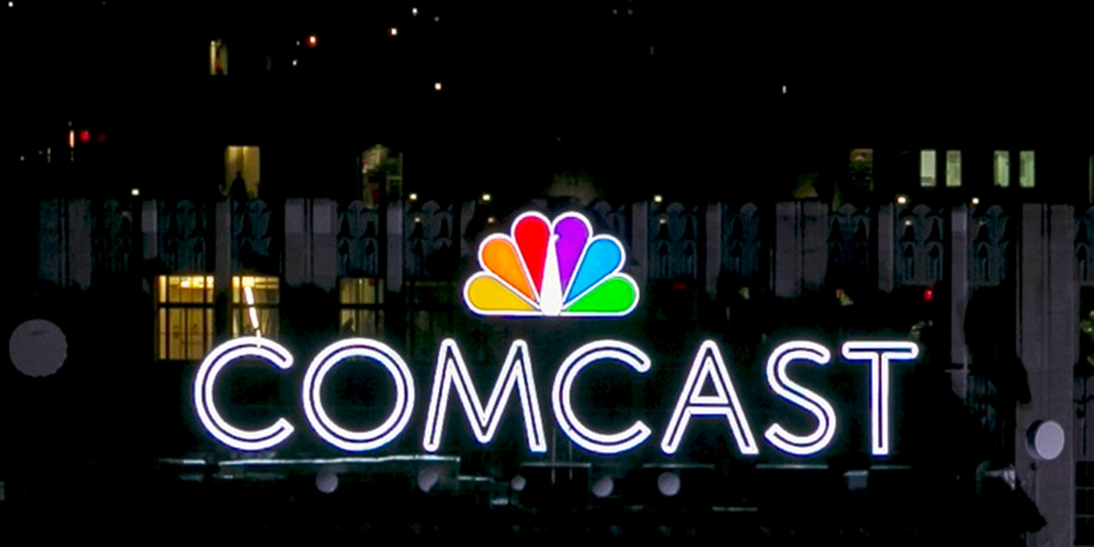 The NBC and Comcast logo are displayed on top of 30 Rockefeller Plaza, formerly known as the GE building, in midtown Manhattan in New York