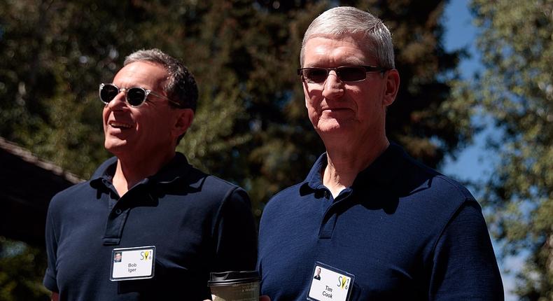 Bob Iger, chief executive officer of The Walt Disney Company, walks with Tim Cook, chief executive officer of Apple Inc., as they attend the annual Allen & Company Sun Valley Conference, July 6, 2016 in Sun Valley, Idaho.