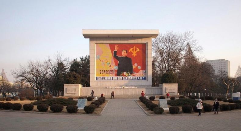 People clean a monument featuring North Korea's founding father Kim Il-Sung in central Pyongyang. The tour agency that took US student Otto Warmbier to Pyongyang says it will stop taking Americans to the reclusive state