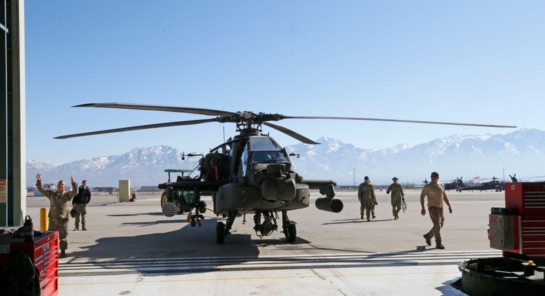 Maintenance workers towing out an Apache helicopter from a hanger in Kearns, Utah.George Frey/Getty Images