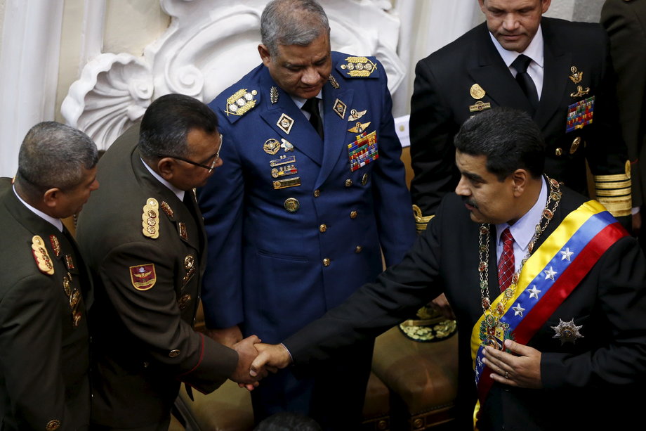 Venezuela's President Nicolas Maduro, right, and Nestor Reverol, then general commander of the Venezuelan National Guard, shake hands during Maduro's annual report of the state of the nation, at the National Assembly in Caracas, January 15, 2016.