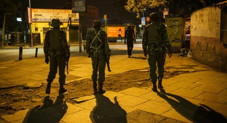 On patrol: Police in central Nairobi during the 7pm-5am curfew