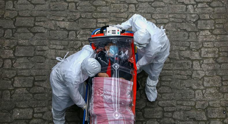 coronavirus covid 19 patient emergency workers protective equipment suits masks gloves south korea march 9 2020 GettyImages 1211268635