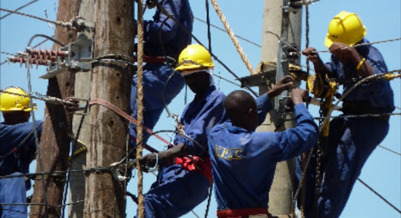 Kenya Power technicians fixing power lines