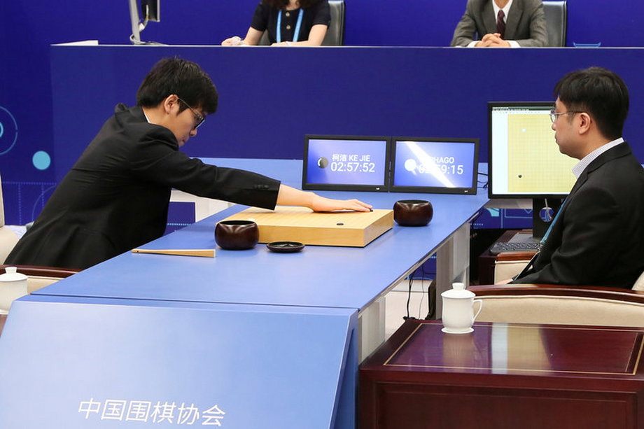 Chinese Go player Ke Jie puts a stone against Google's artificial intelligence program AlphaGo during their first match at the Future of Go Summit in Wuzhen