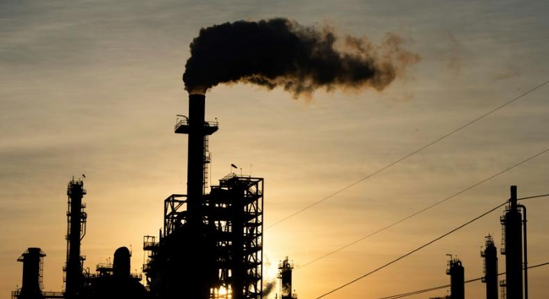 The sun sets behind smoke rising from the LyondellBasell-Houston Refining plant in Houston, Texas, as US crude futures fell below zero for the first time