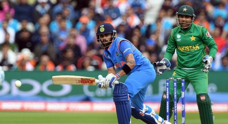 India's Virat Kohli (L) bats as Pakistan wicket-keeper Sarfraz Ahmed looks on during the ICC Champions trophy match at Edgbaston in Birmingham, central England on June 4, 2017