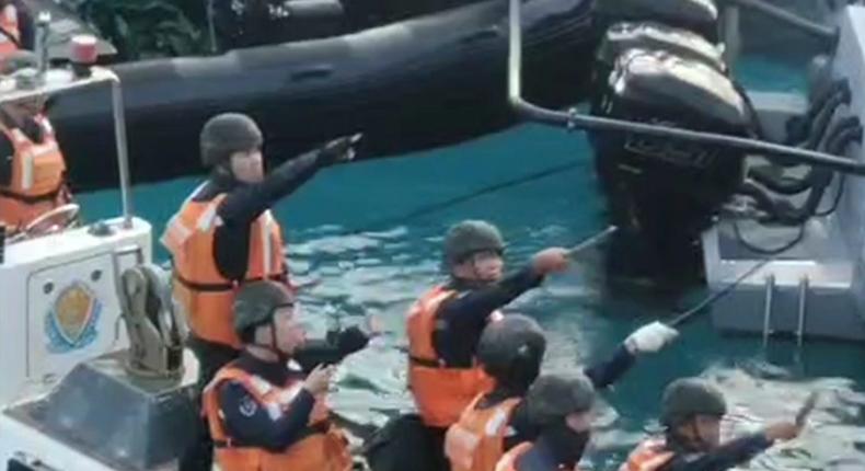 Chinese coast guard holding knives and machetes as they approach Philippine boats in the disputed South China Sea on June 17, 2024.Armed Forces of the Philippines via AP, File