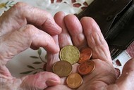 Old woman holds coins