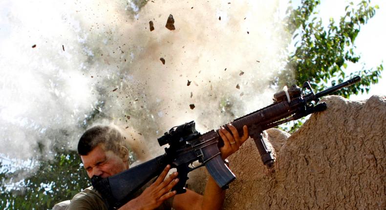 Sgt. William Olas Bee, a US Marine from the 24th Marine Expeditionary Unit, has a close call after Taliban fighters open fire near Garmsir district, in Helmand province, in May 2008.